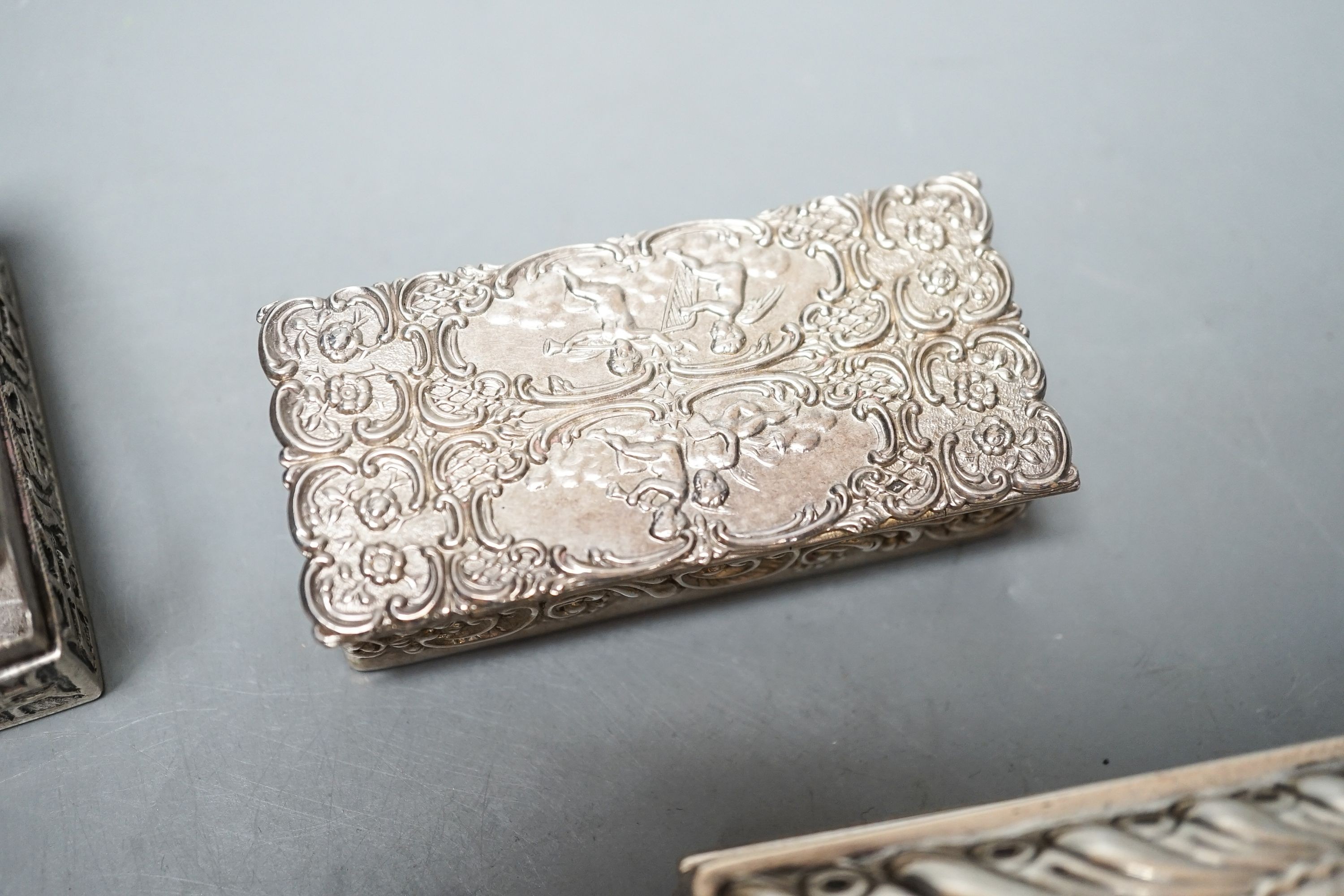A late Victorian silver ring box, London, 1895(a.f.), 97mm, a later silver snuff box and two white metakl boxes.